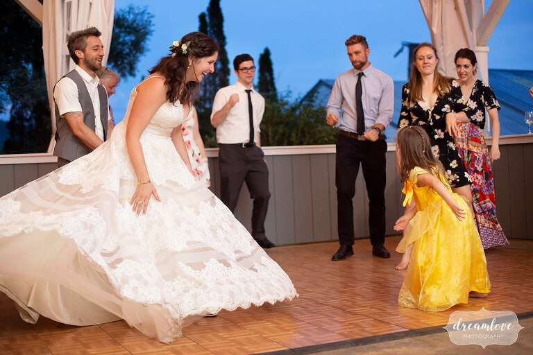 Bride dances with flower girl at Warfield House Inn.