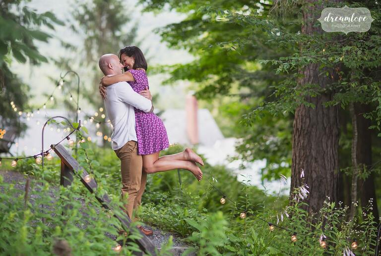 Southern Vermont engagement photographer captures guy picking up girl in the woods.