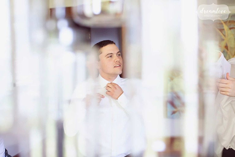 Artistic portrait of the groom getting ready at the Warfield House Inn.