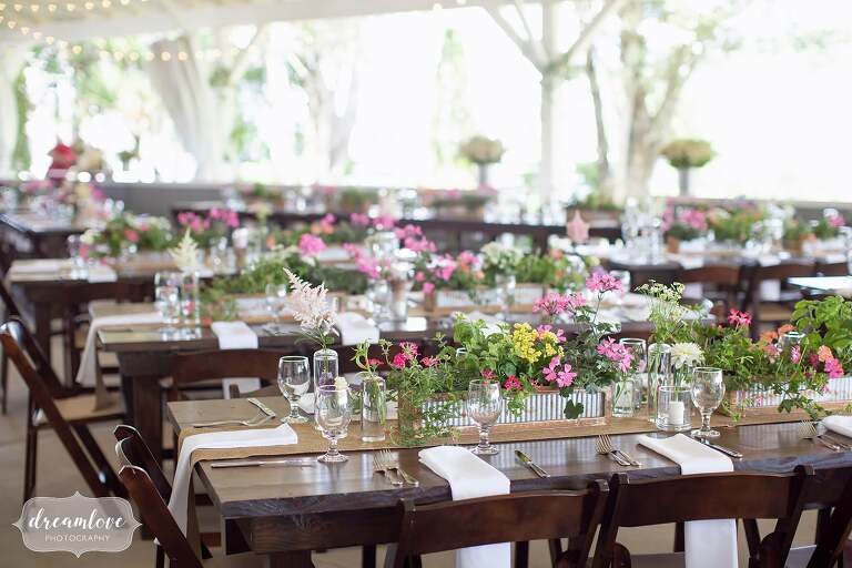 Rustic wildflowers and family style tables for dinner set up at Warfield House Inn.