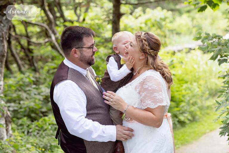 Great candid wedding photographer captures toddler kissing bride.