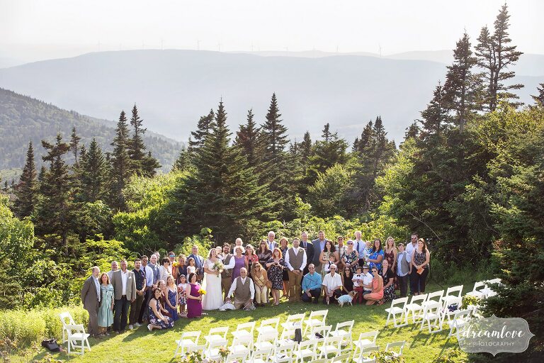 All of the wedding guests are pictured on top of Mt. Greylock for this summer wedding outside.