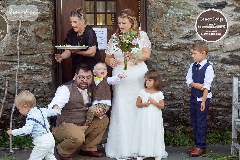 Hilarious photo of the bride and groom trying to pose with a bunch of kids at Bascom Lodge.