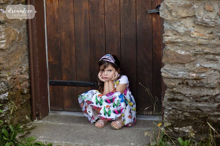 A mad little girl pouts in front of Bascom Lodge during a wedding.