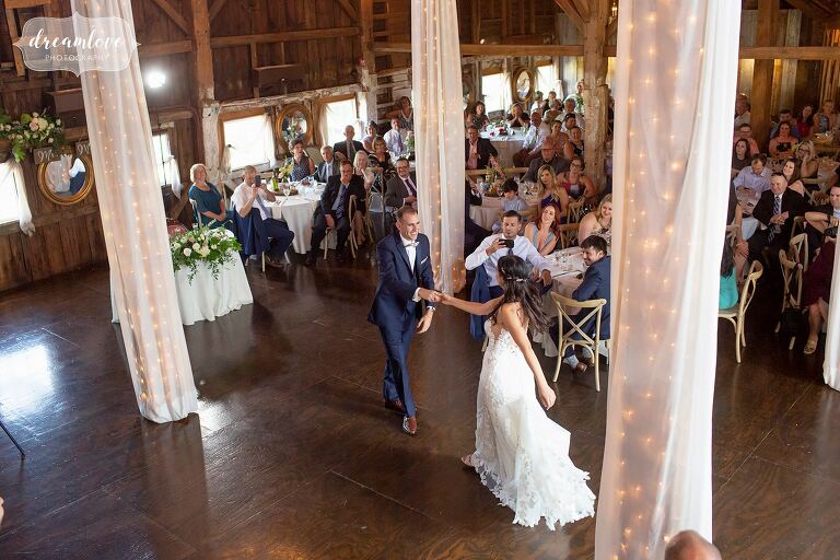 Bride and groom have first dance in NH barn.