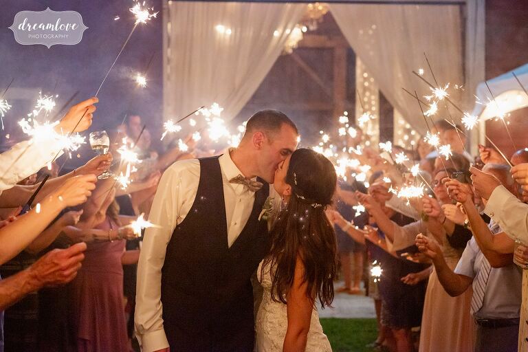 Bride groom kiss sea of sparklers NH barn wedding.