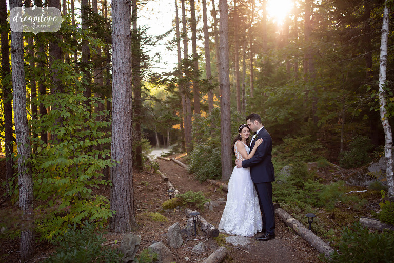 Bride and groom pose in the woods at their Kennebunkport wedding at Hidden Pond.