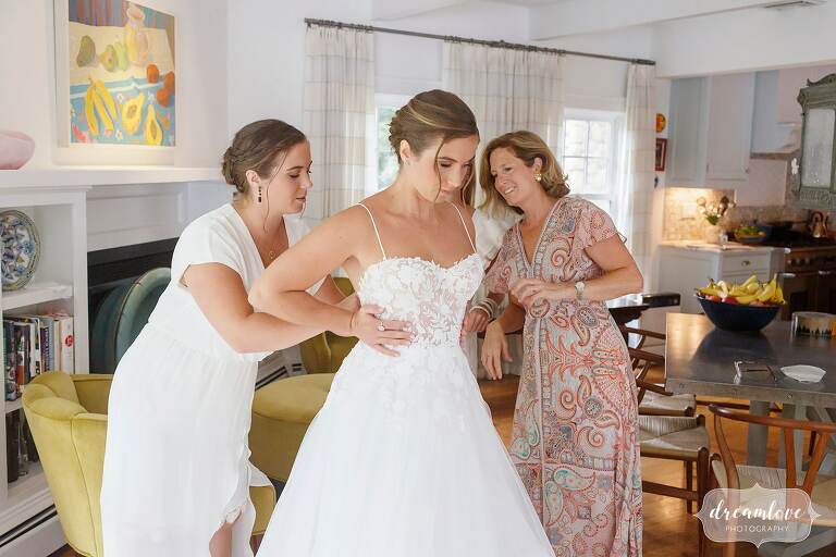 Bride puts on her luxury wedding gown for her beach club CT wedding.
