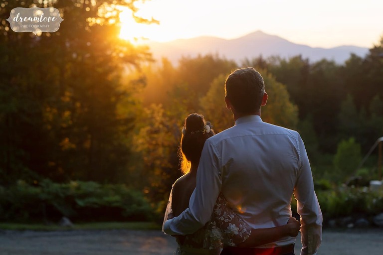 Couple looks at the mountains during sunset in Stowe, VT.