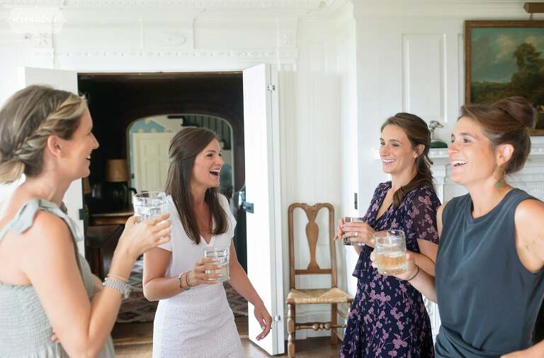 The bride laughs with her bridesmaids at the Brick House in VT.