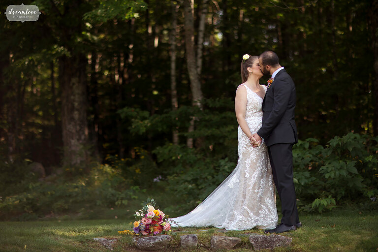 White mountains of NH wedding venue with bride and groom kissing.