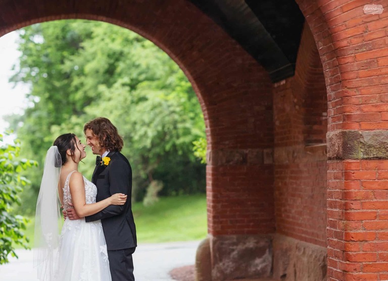 Bride and groom kiss under the arch at the Stevens Estate.