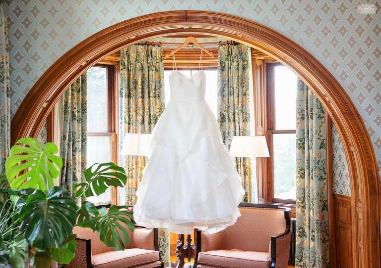 Bride's dress hangs inside of the Stevens Estate in North Andover, MA.